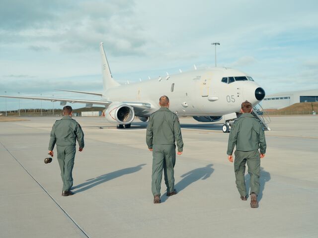 Royal Air Force personnel walk toward a Poseidon MRA1 maritime patrol aircraft at RAF Lossiemouth in northeast Scotland. The aircraft, also known as P-8s, are used for anti-submarine warfare and surveillance missions in the North Atlantic.