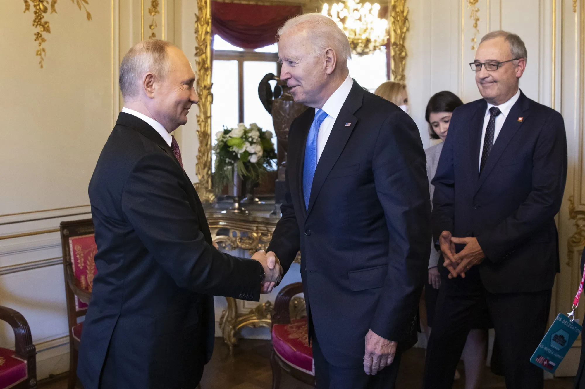 Vladimir Putin, left, shakes hand with Joe Biden in Geneva, on June 16.