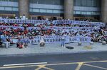 Demonstrators hold banners during a protest at the entrance to a branch of China's central bank in Zhengzhou on July 10.