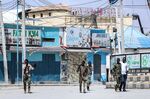 Security officers patrol near the the site of explosions in Mogadishu on Aug. 20.