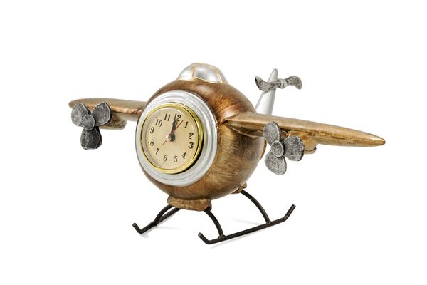 Statuette of vintage airplane with clock isolated on white background