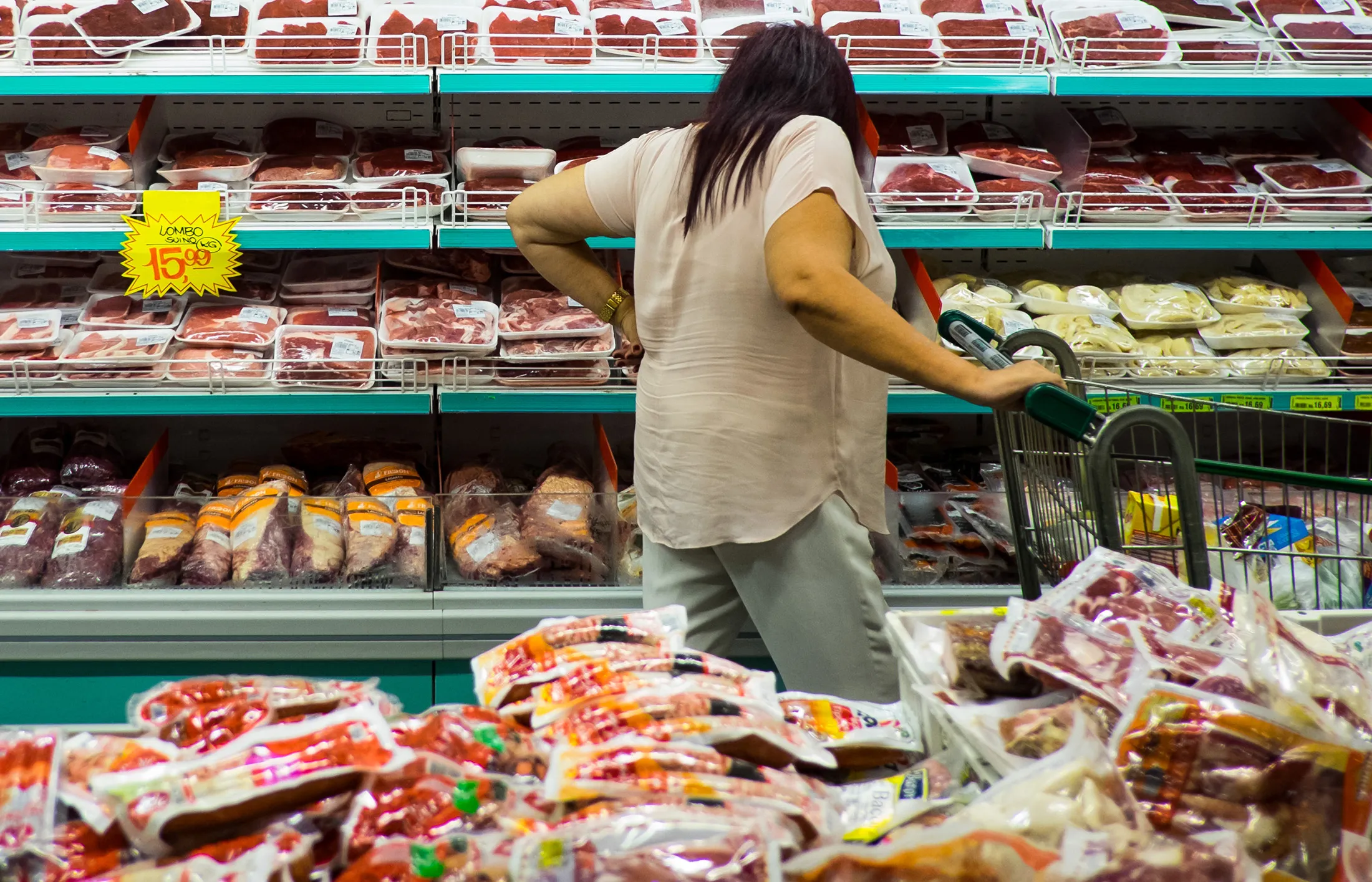 A customer shops for meat in a supermarket in Sao Paulo, Brazil.