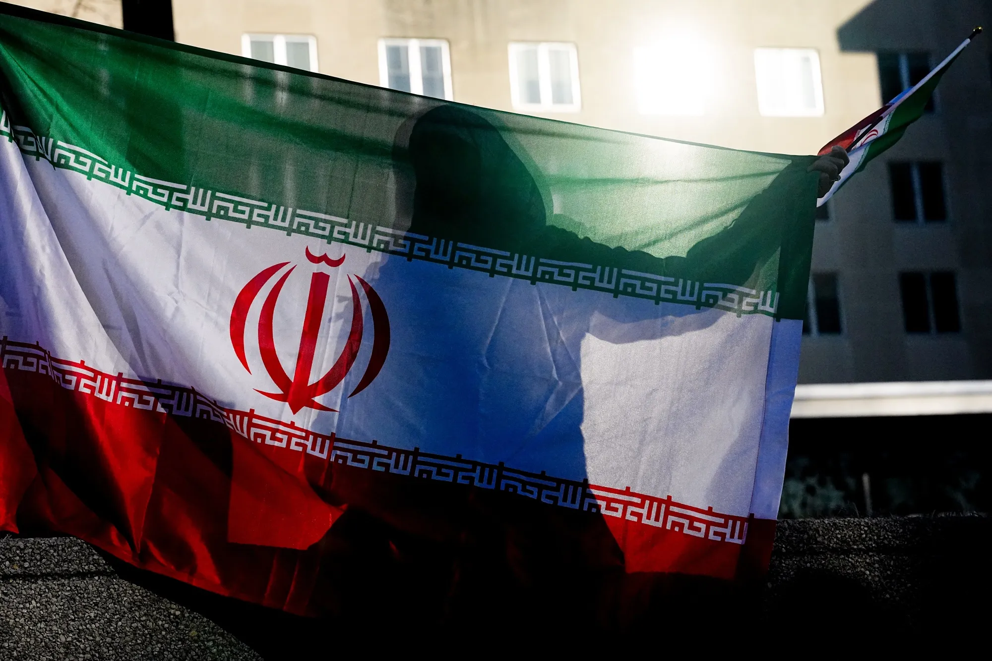 A demonstrator holds an Iranian flag during a protest in Washington on Feb. 28, after the killing of Ayatollah Ali Khamenei, Iran’s supreme leader.