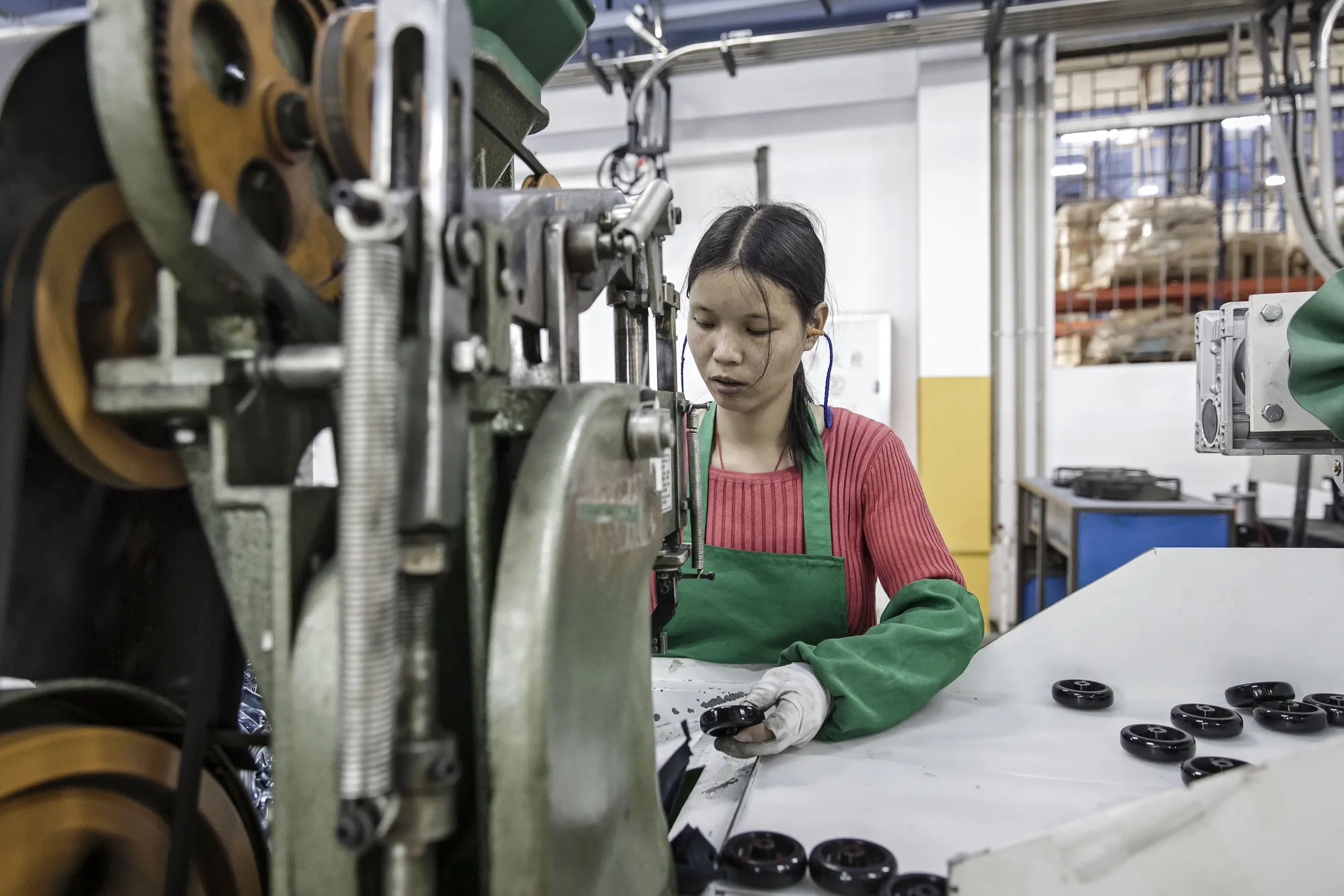 A workers handles a caster wheel at a factory&nbsp;in Foshan, China.