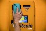 A customer scans a mobile phone QR code on cryptocurrency ATM in Barcelona.