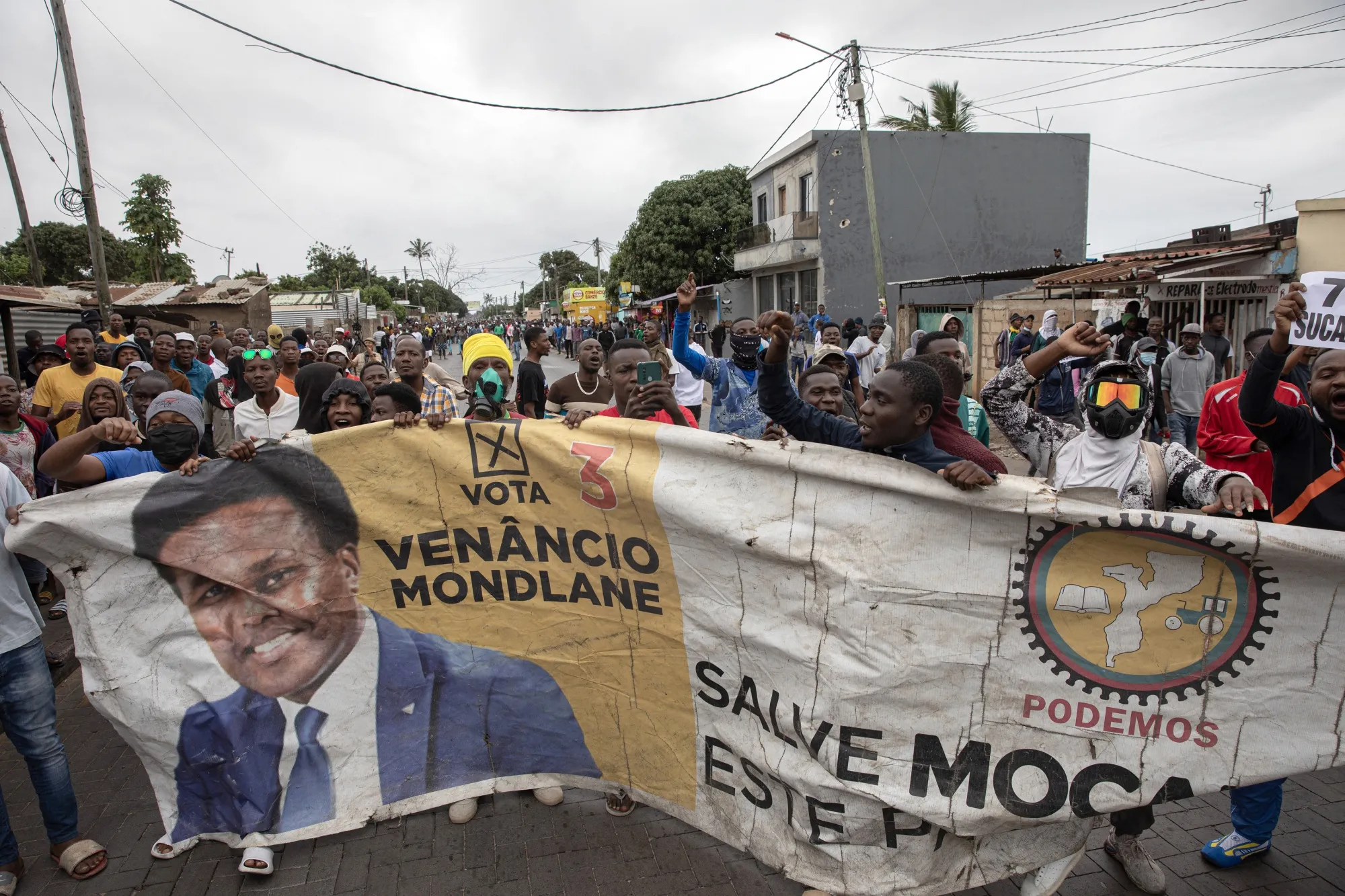 Protesters with a banner depicting Mondlane in Maputo on Nov. 7.