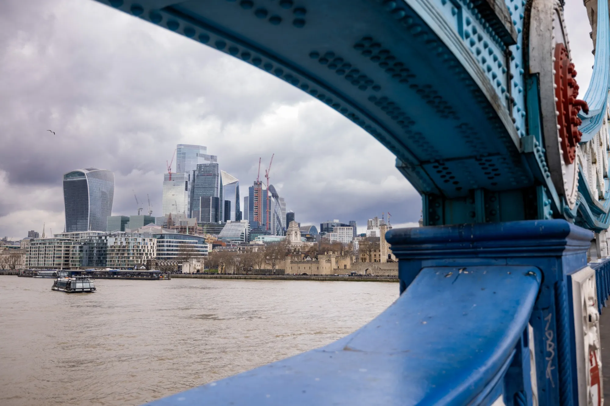 Skyscrapers in the City of London skyline framed by Tower Bridge.