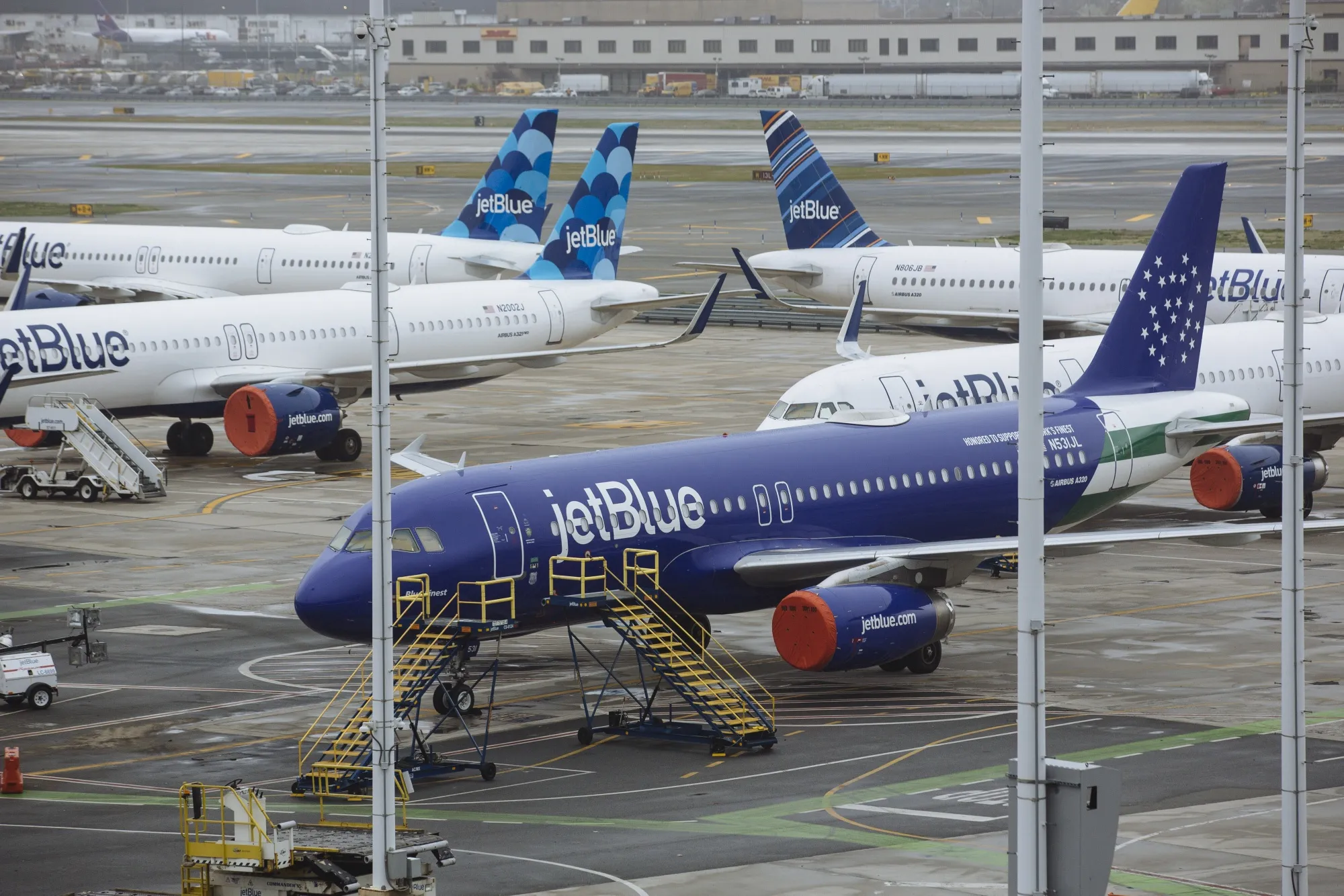 JetBlue Airways Corp. aircraft sit with their engines covered at John F. Kennedy International Airport (JFK) in New York, U.S., on&nbsp;April 9.