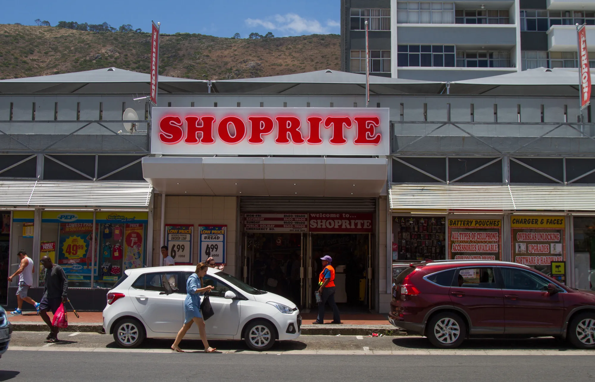 Pedestrians pass the entrance to a Shoprite store in South Africa.
