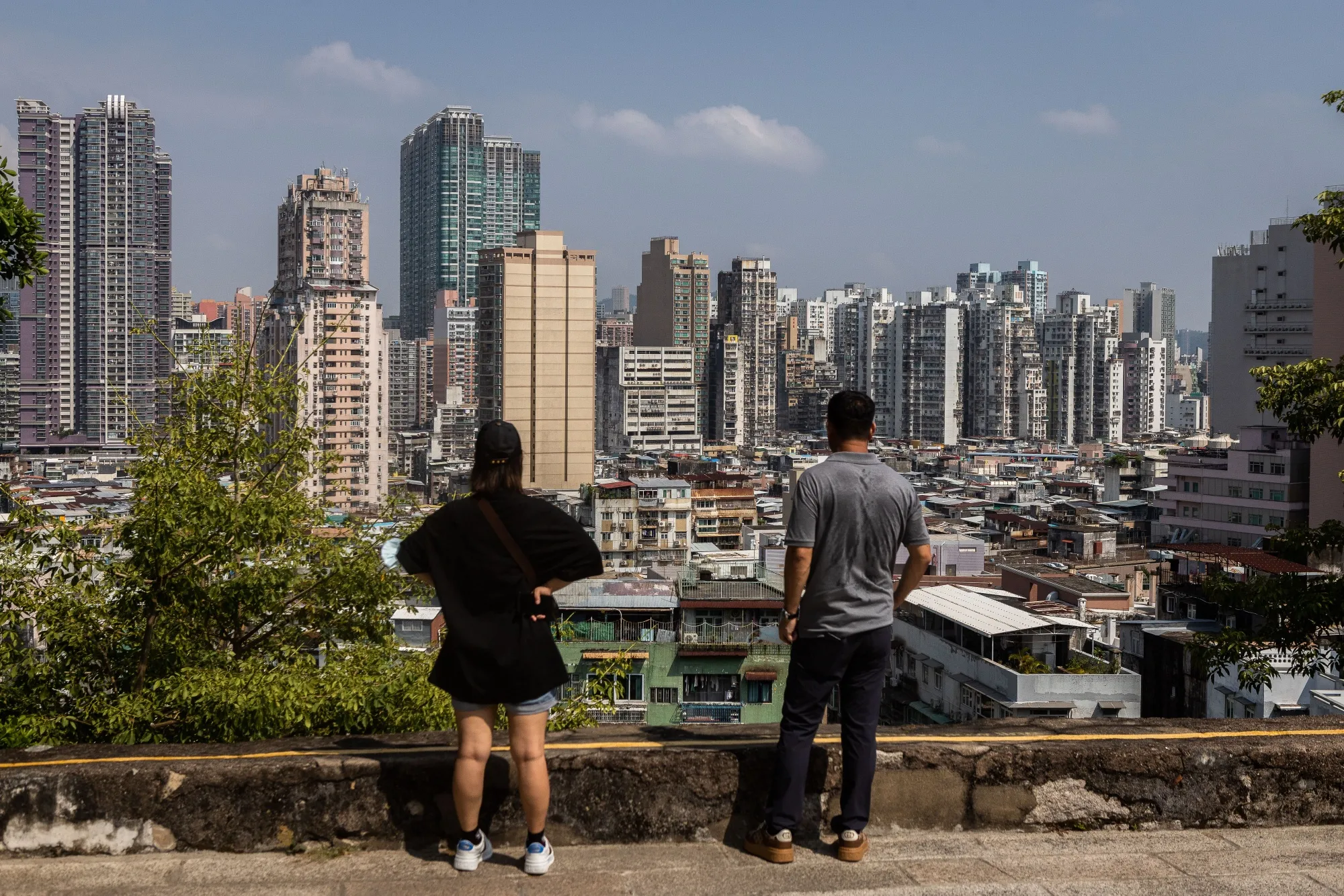 Visitors against the city skyline at Mount Fortress in Macau, China.