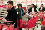 Shoppers line up to check out at a Target store in Chicago. Consumer confidence is at its lowest level since 1993, according to the Conference Board. 