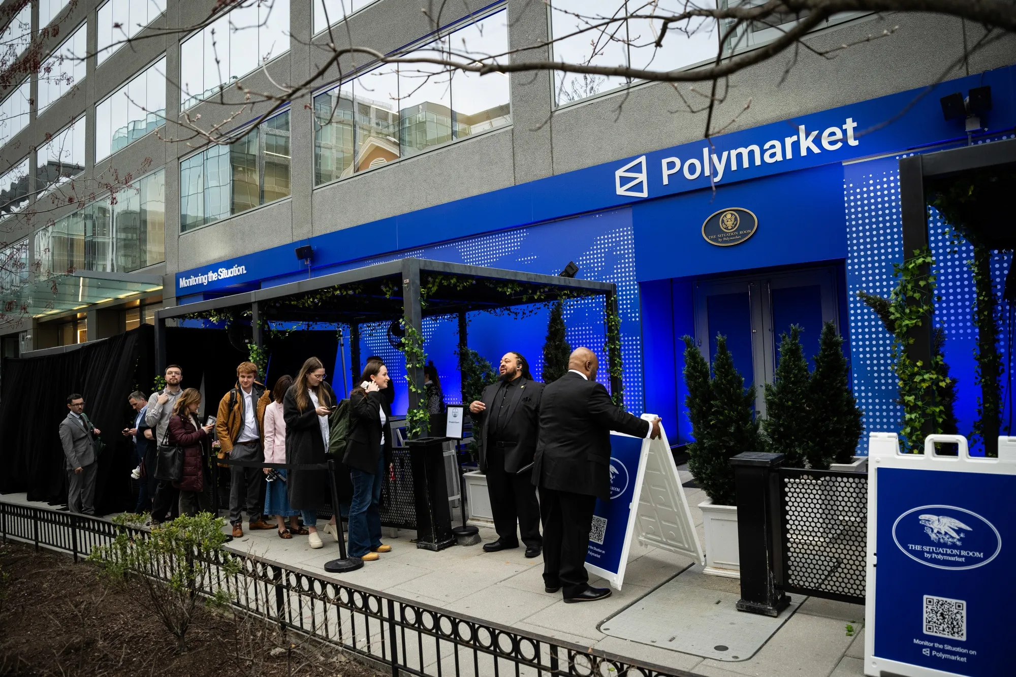Attendees wait in line outside the Situation Room by Polymarket pop-up bar in Washington.