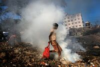 Children collect goods from the garbage in the Buriganga River in Dhaka in Dec. 2020. Methane concentrations in the country likely originate from many sources including paddy fields, landfills, leaky natural gas pipelines and coal stockpiles.