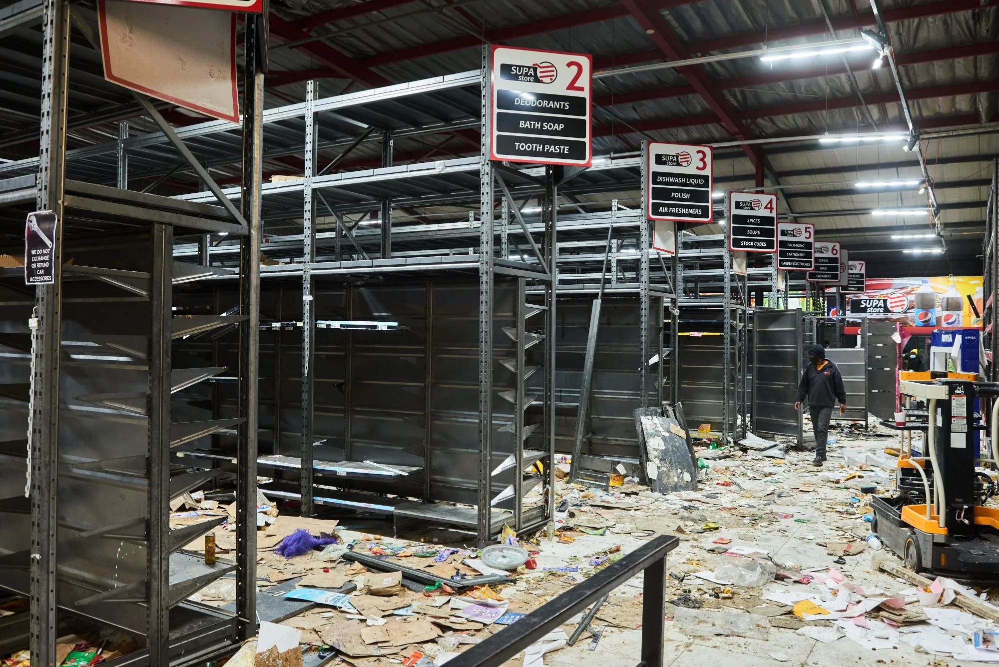 Debris cover the floor between empty shelves inside a Supa Store supermarket following rioting in the Soweto district of Johannesburg, on July 15.