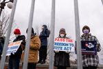 A demonstrator holds a sign reading &quot;Pass the Freedom to Vote Act&quot; during a protest at the U.S. Capitol in Washington, D.C., on Jan. 20.