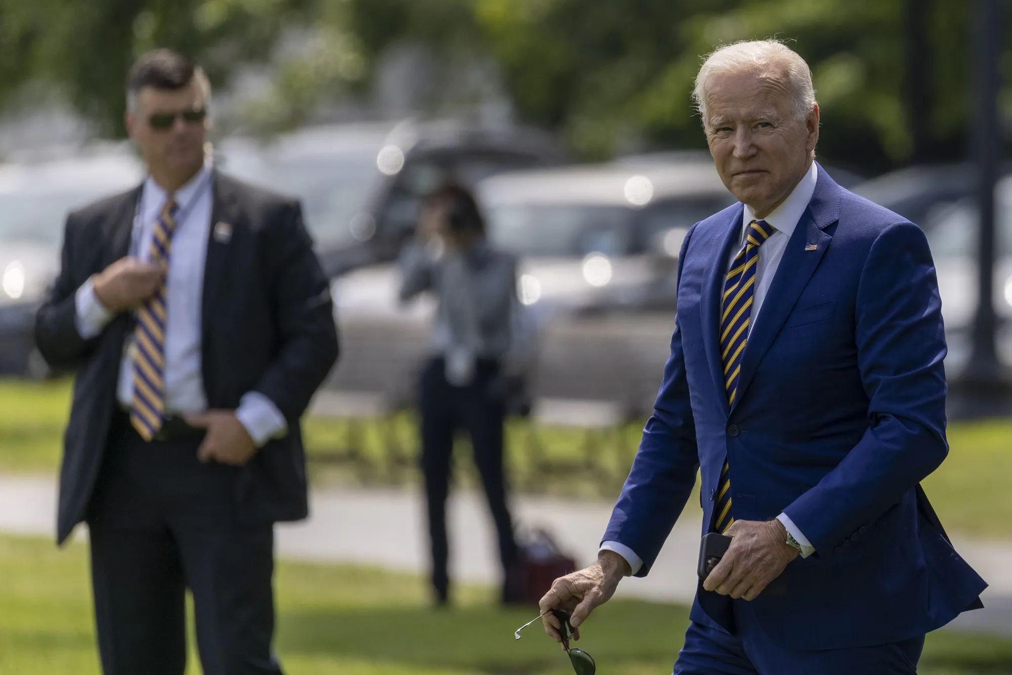President Biden walks on the Ellipse near the White House before boarding Marine One.