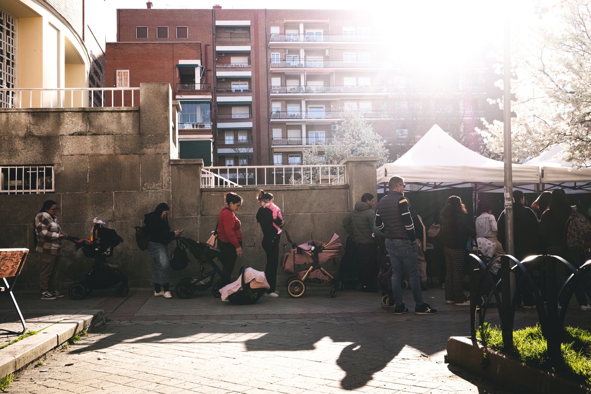 People wait in line for assistance outside the Fundacion Madrina in Madrid, Spain, on Friday, March 13, 2026.