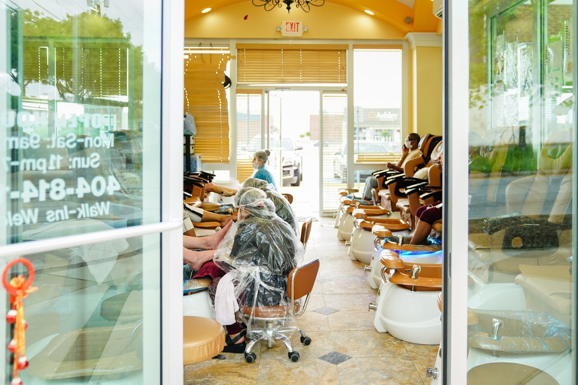 Workers wearing protective gear give customers pedicures at a newly reopened nail salon in Atlanta, Georgia,&nbsp;on&nbsp;April 24.