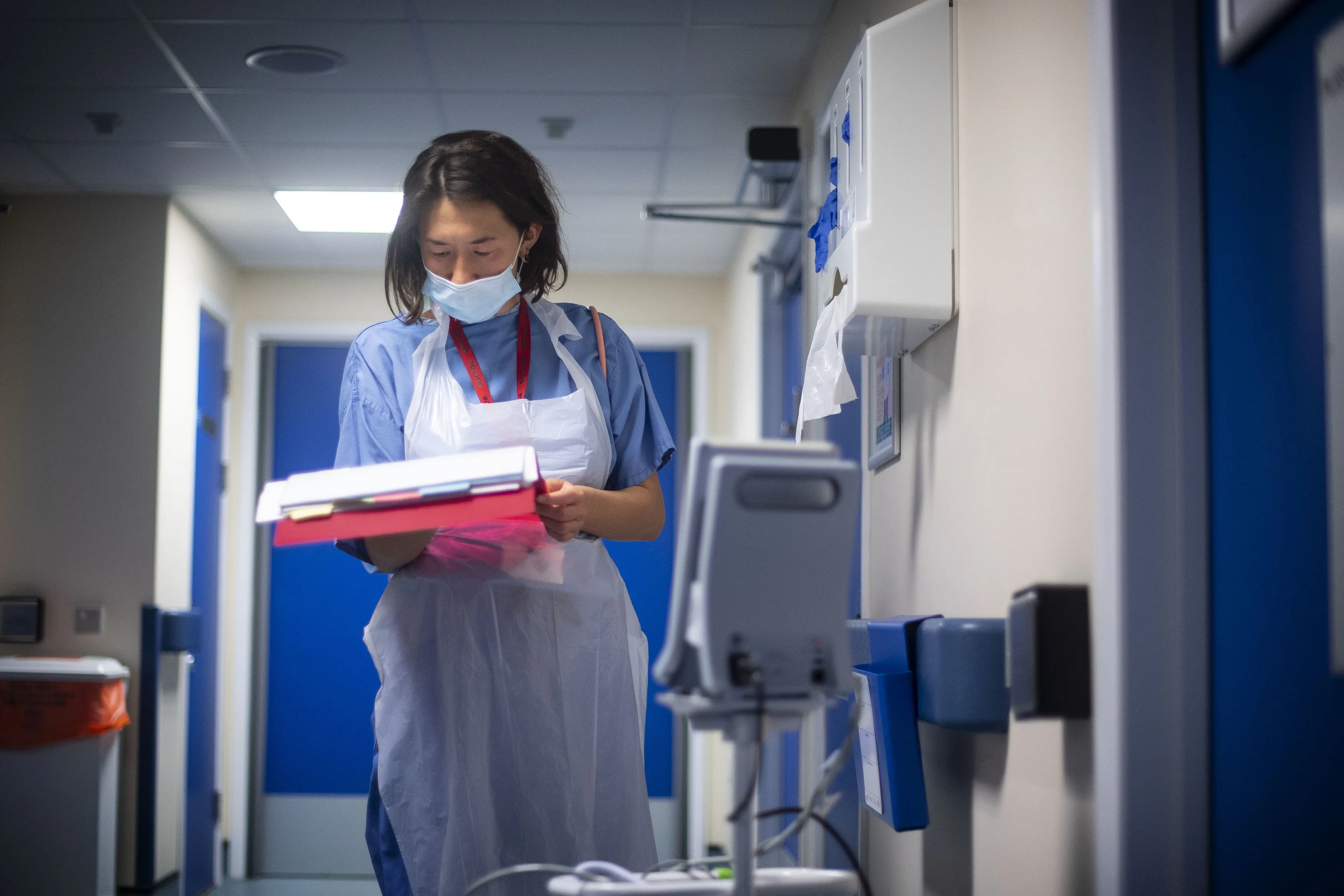 A doctor checks on patient notes.