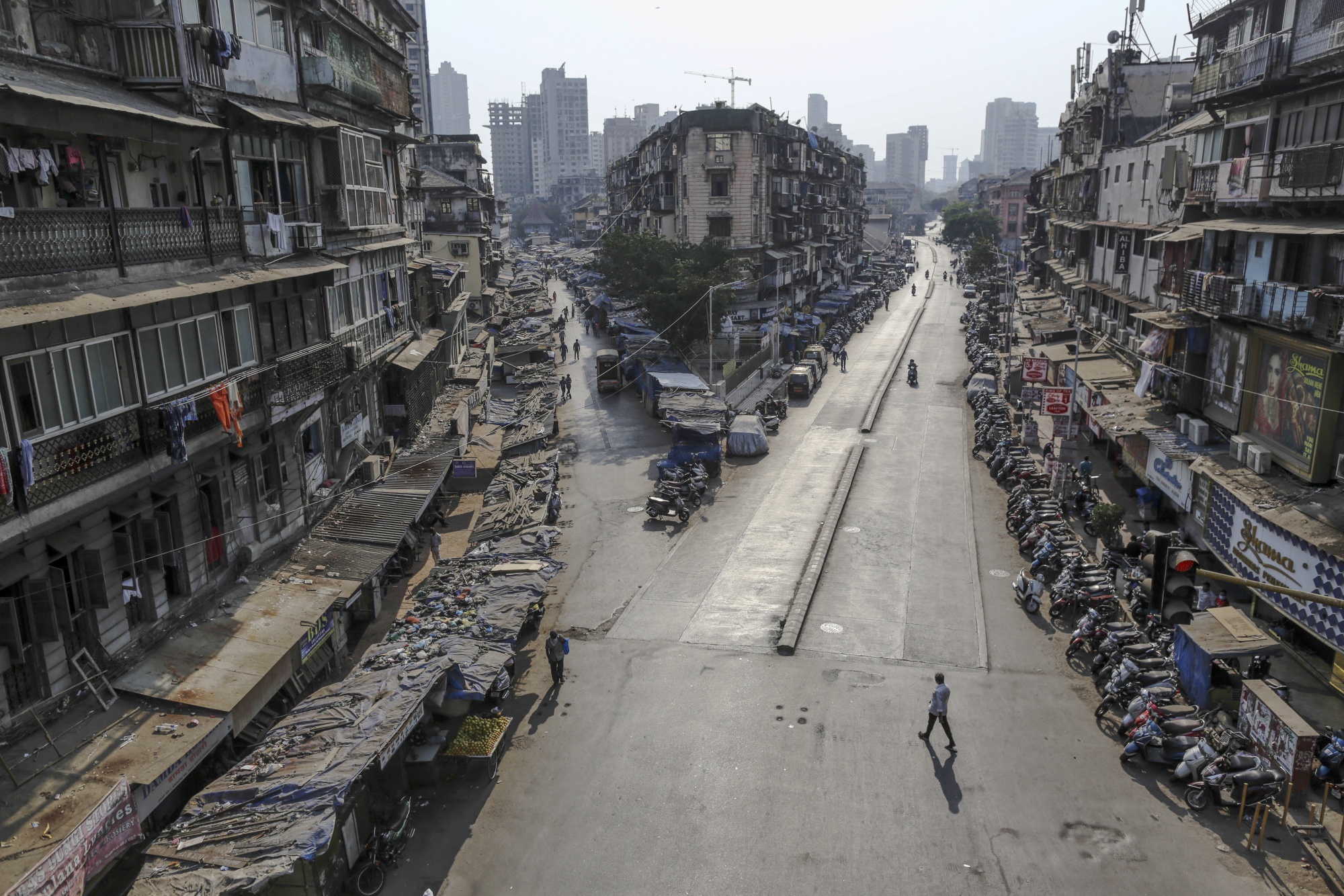 Pedestrians walk along near-empty roads during a lockdown in Mumbai, India, on March 25.