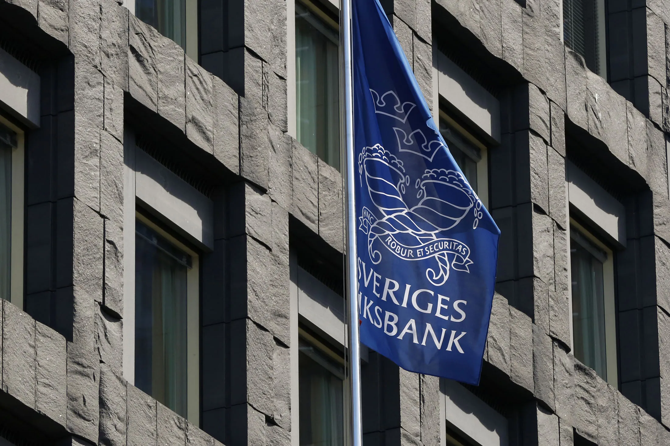 A Riksbank banner flies outside the headquarters of the Swedish central bank in Stockholm, Sweden