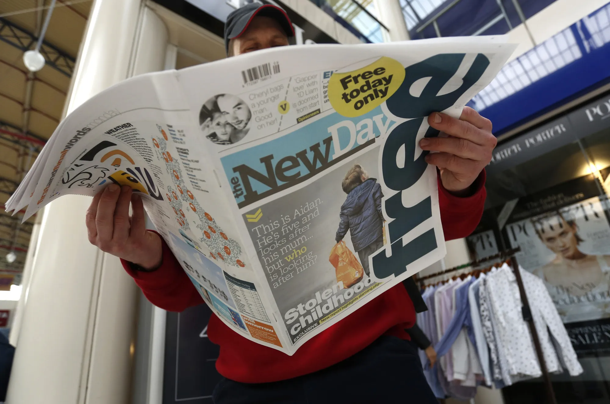 A man reads the 'New Day' newspaper on launch day, Monday, Feb. 29, 2016.
