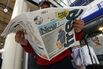 A man reads the 'New Day' newspaper on launch day, Monday, Feb. 29, 2016.
