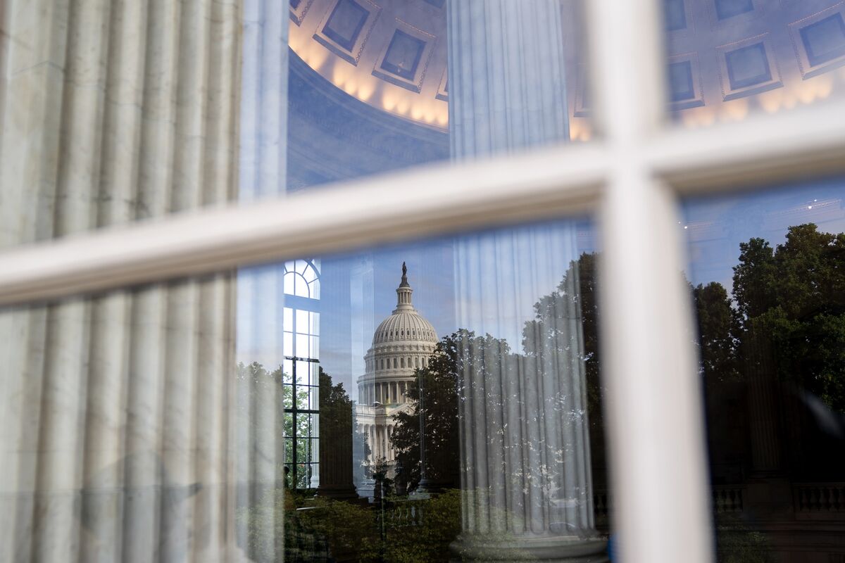 Man looking through window at cityscape stock photo - OFFSET