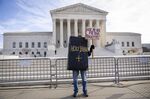 A demonstrator outside the Supreme Court in Washington, DC, on Dec. 5.