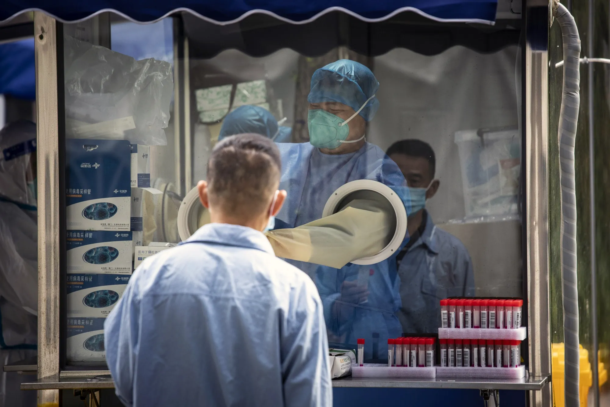 A healthcare worker&nbsp;collects a swab sample at a Covid-19 testing facility in Shanghai, China, on&nbsp;May 31.