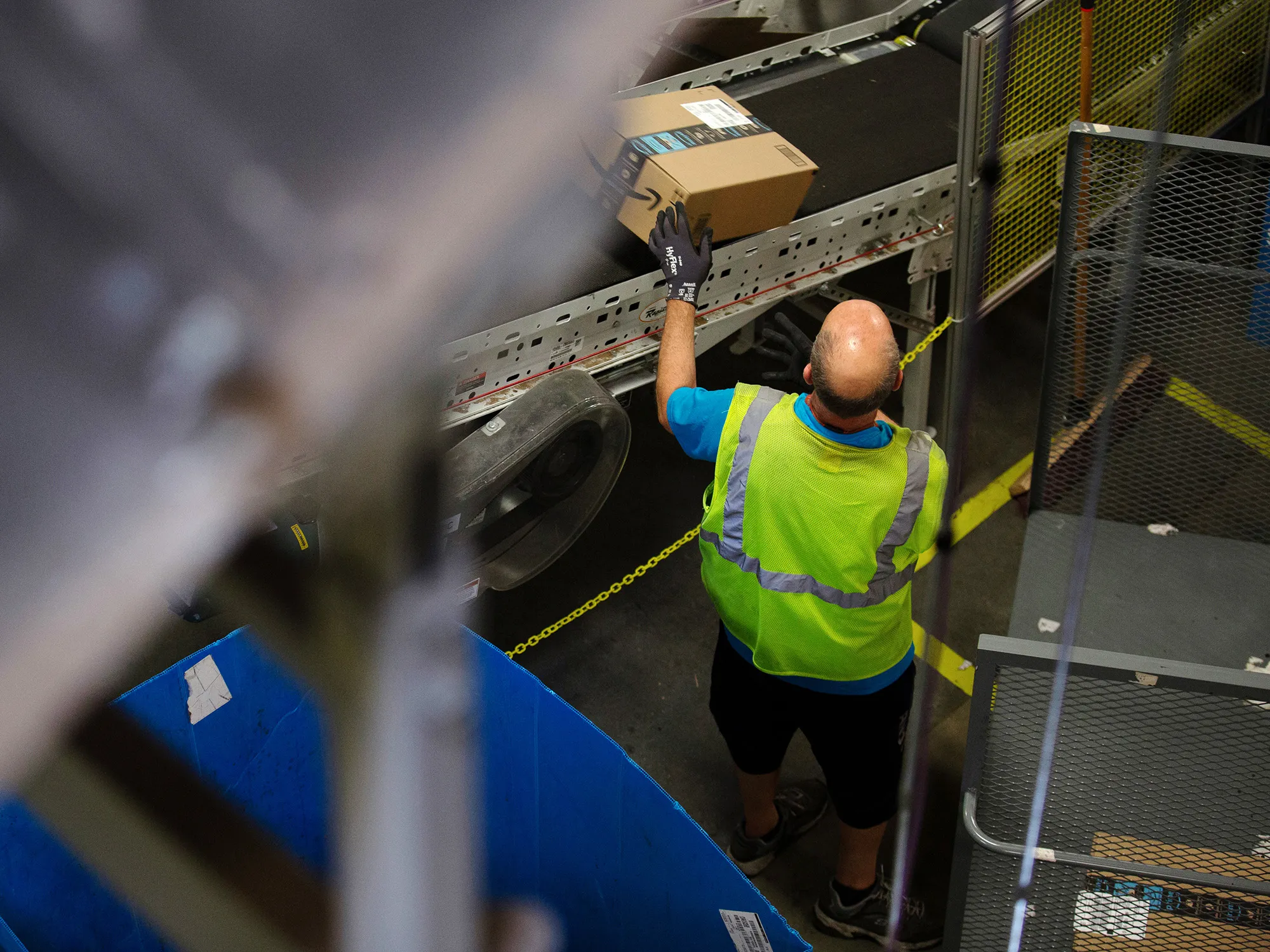 An employee collects a package from a conveyor at the Amazon.com Inc. fulfillment center in Robbinsville, New Jersey.