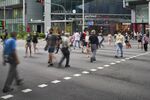 Pedestrians wearing protective masks cross a road in Singapore.