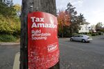 A poster for Seattle city councilmember Kshama Sawant that reads &quot;Tax Amazon.&quot;