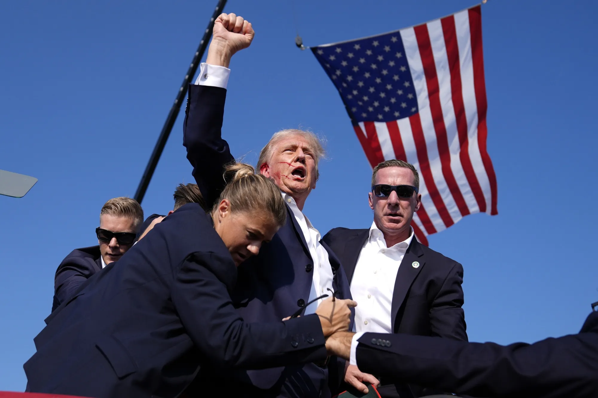 Donald Trump surrounded by US Secret Service agents after an assassination attempt in Butler, Pennsylvania, on July 13. &nbsp;(AP Photo/Evan Vucci, File)