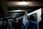 A person wearing a protective mask waits for a Bay Area Rapid Transit (BART) train in San Francisco.