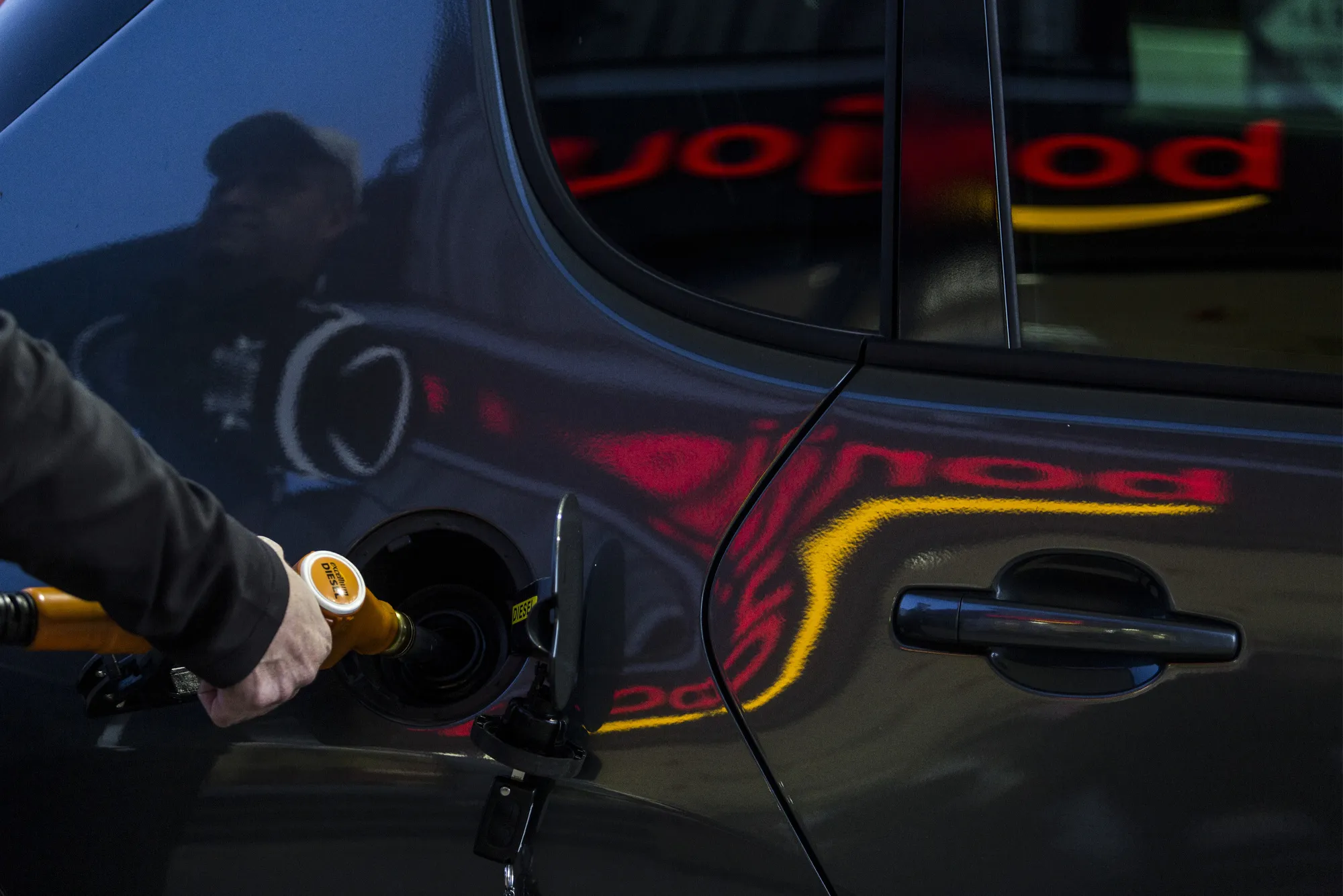 A customer refuels his automobile on the forecourt of a gas station near Rodez.
