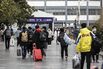 Travelers at Shanghai Railway Station As China's Top Medical Adviser Says Omicron's Risks Same as Flu