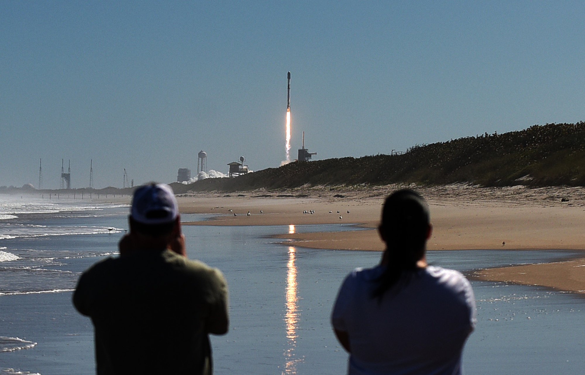 People watch from Canaveral National Seashore as a SpaceX Falcon 9 rocket carrying Starlink internet satellites launches from&nbsp;the Kennedy Space Center in Cape Canaveral, Florida, on Feb. 3.