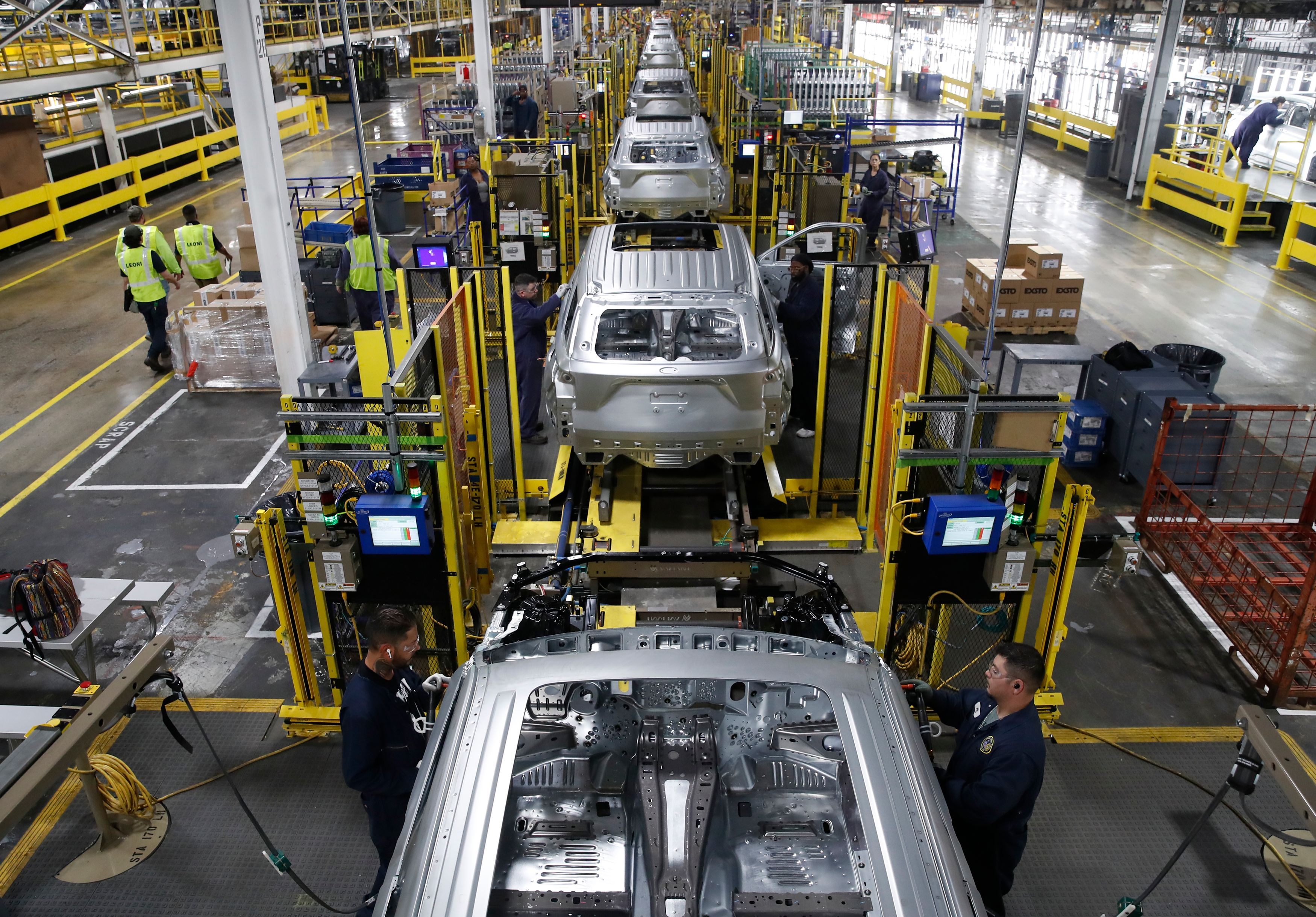 Workers assemble cars at the Ford's Assembly Plant in Chicago.