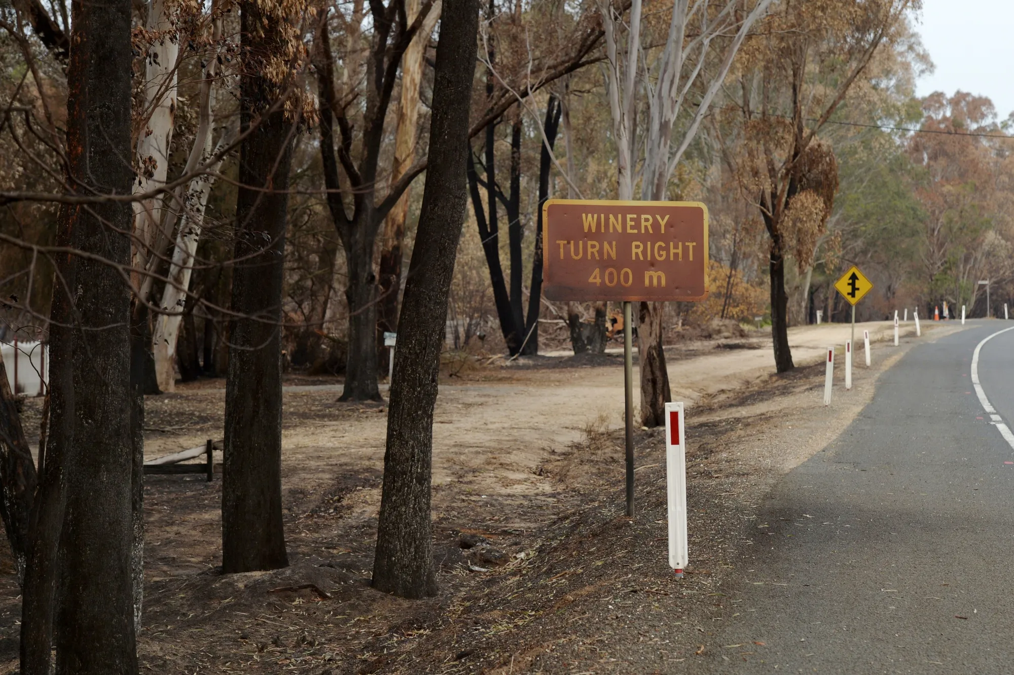 A winery sign scorched by wildfires stands along a road in Sarsfield, East Gippsland on Jan. 9