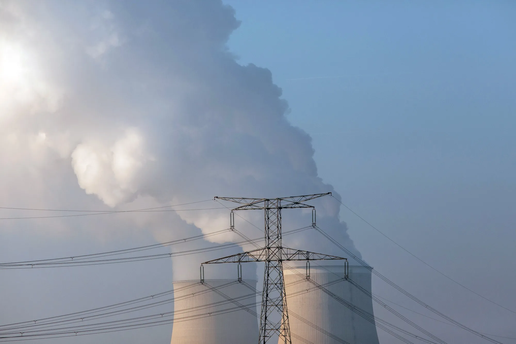 Cooling towers release water vapor beyond electricity lines at the Nogent nuclear power plant,&nbsp;in Nogent-sur-Seine, France.