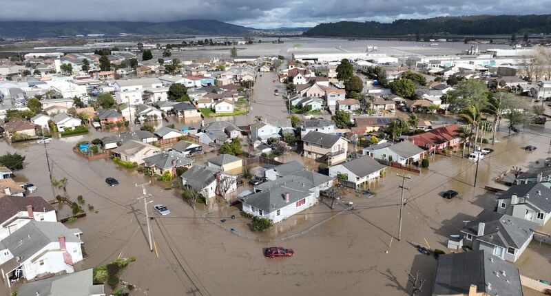Vehicles and homes engulfed by floodwaters in Pajaro, California, on Saturday, March 11, 2023.