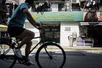 A cyclist rides past a Postal Savings Bank of China branch in Shanghai.