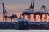 The Marcarrier container ship sails past gantry cranes at a shipping terminal in Yokohama, Japan, on Monday, Dec. 15, 2014. Japan’s exports rose less than forecast in November, underlining challenges to Prime Minister Shinzo Abe’s efforts to steer the economy out of recession.
