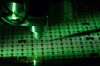 A machine places single solder balls onto a printed circuit board (PCB) during manufacture at the Infineon Technologies AG microchip and sensor facility in Regensburg, Germany, on Wednesday, Feb. 17, 2016. Infineon designs, manufactures and markets semiconductors for the automotive, industrial, communications, consumer and security electronics sectors.