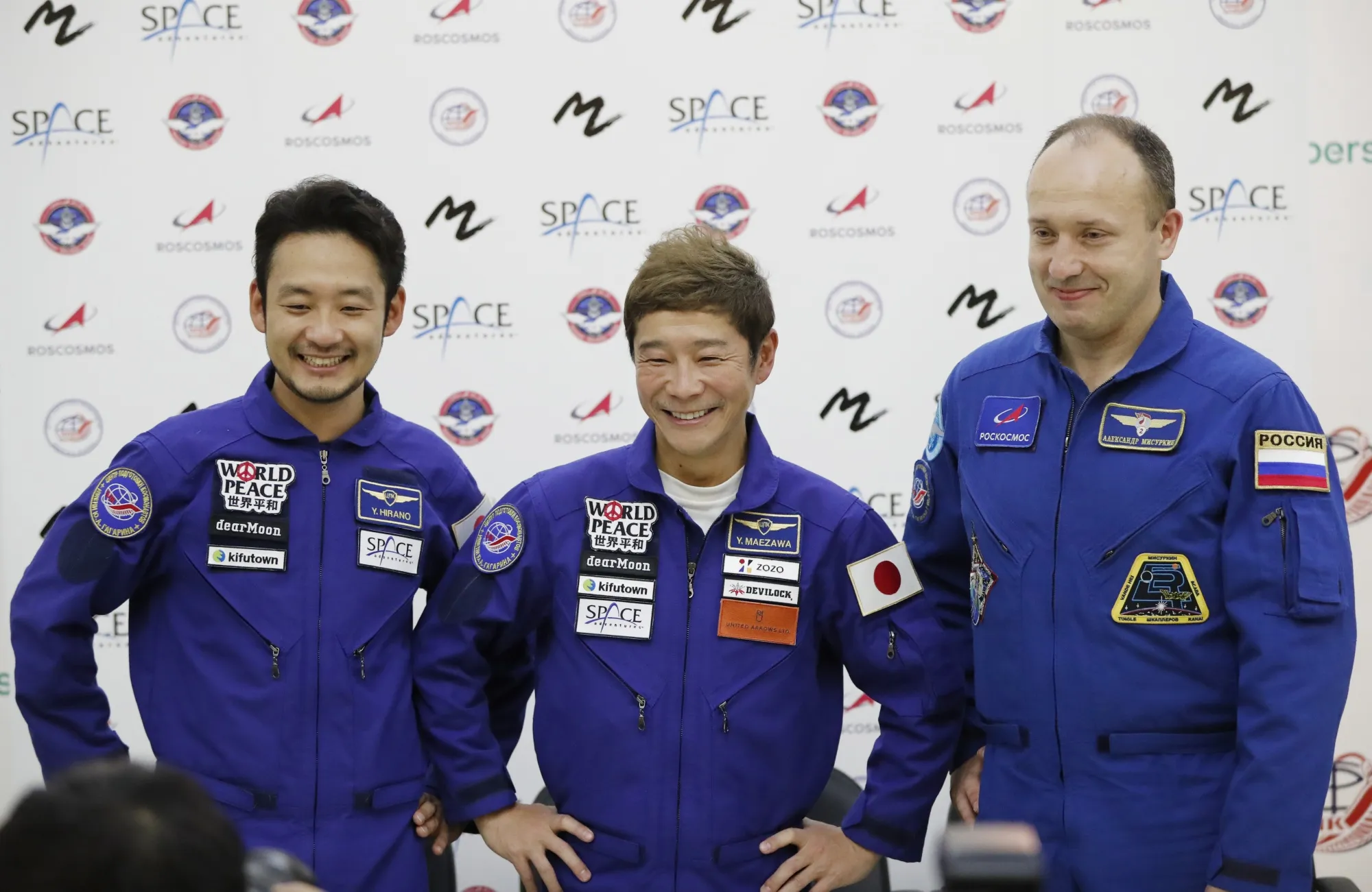 Roscosmos cosmonaut Alexander Misurkin, right, space flight participants Yusaku Maezawa, center, and Yozo Hirano attend a news conference ahead of the expedition to the International Space Station at the Gagarin Cosmonauts' Training Center in Star City outside Moscow, Russia, Oct. 14, 2021. During an interview with the Associated Press on Monday, Dec. 13, 2021, Maezawa said he experienced motion sickness after arriving at the space outpost and it took him a few days to adapt to zero gravity. (Shamil Zhumatov/Pool Photo via AP)