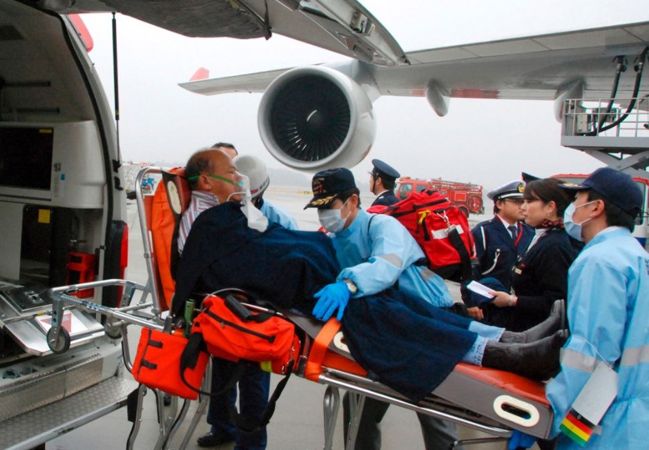 Emergency crews unload a man from an airplane that was hit by turbulence while flying from Manila to Tokyo in 2009, injuring 30 people.