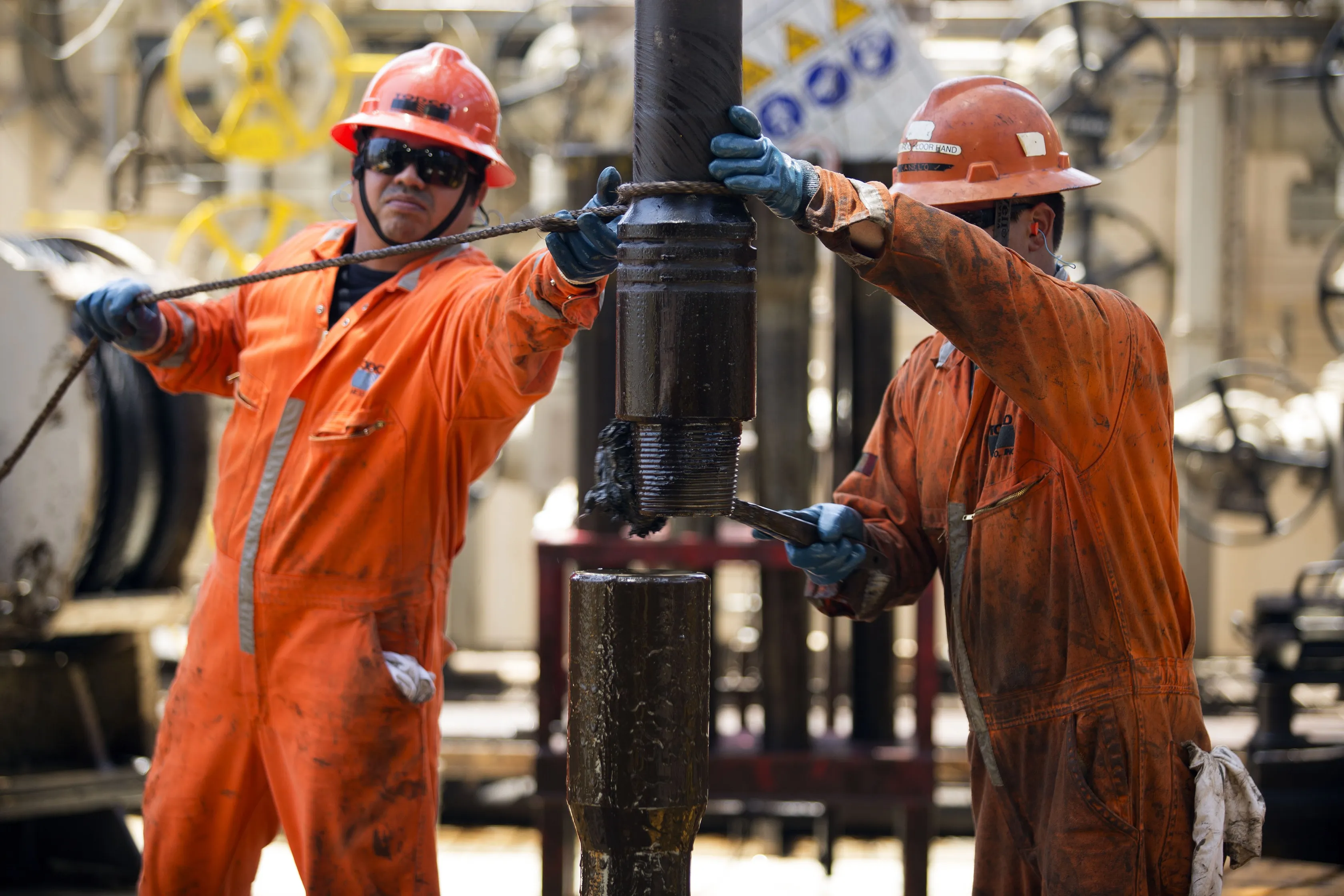 Workers change a drill pipe on an oil drilling rig operated by Petroleos Mexicanos off the coast of Ciudad del Carmen, Mexico.