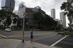 A pedestrian stands at a traffic junction during a partial lockdown imposed due to the coronavirus in Singapore on April 7.
