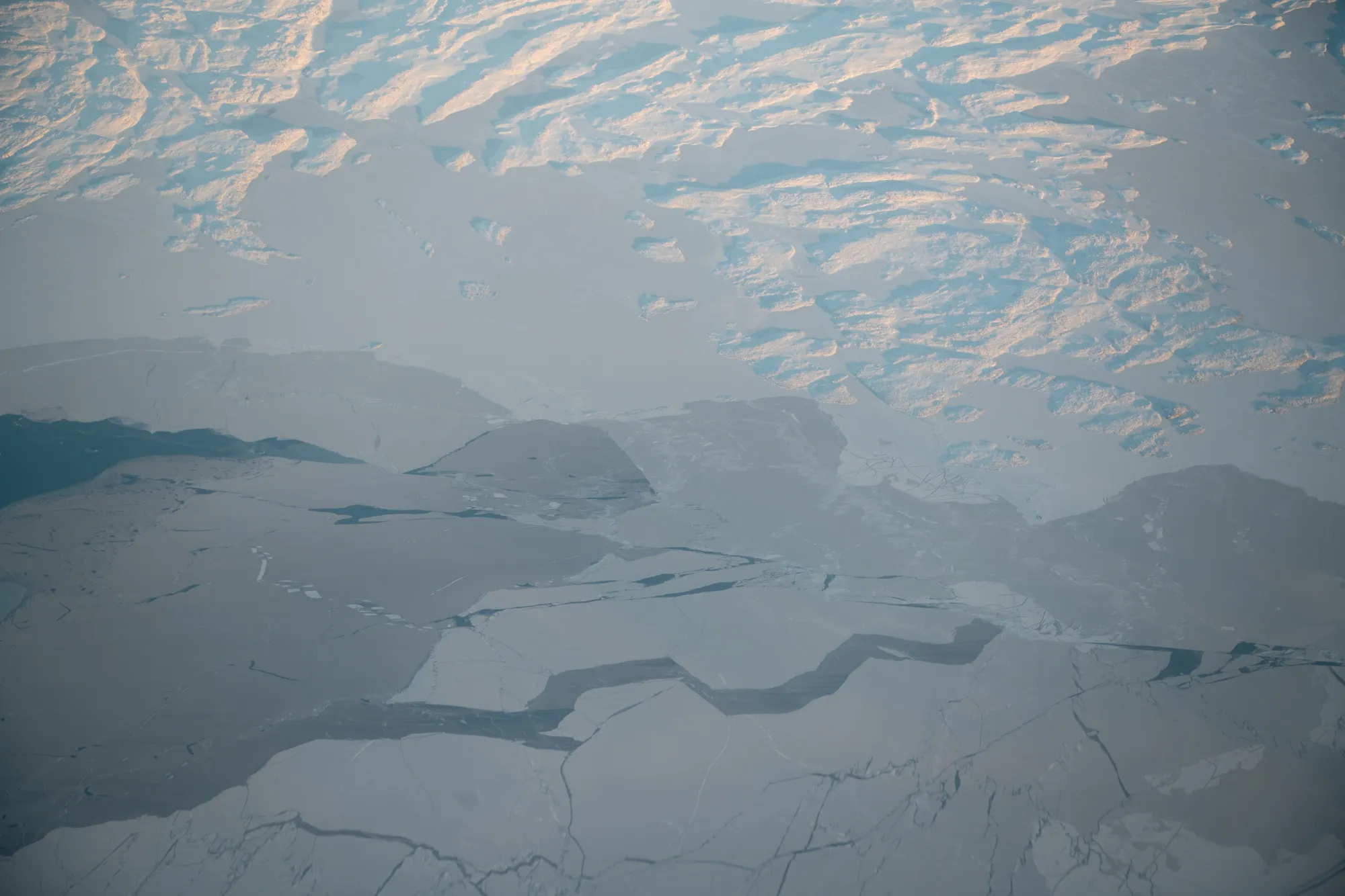 Ice forming from the window of an airplane heading from Iqaluit to Pond Inlet, Nunavut, Canada, on Wednesday, Nov. 10, 2021.&nbsp;